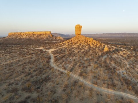 The Vingerklip (rock finger) and the Ugab Valley Terraces are surrounded by thornbush and mopane (Colophospermum mopane) savanna. Aerial view. Drone shot. Damaraland, Namibia