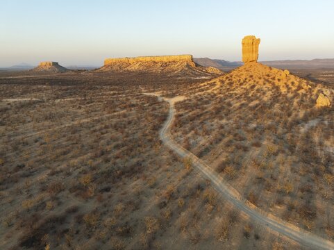 The Vingerklip (rock finger) and the Ugab Valley Terraces are surrounded by thornbush and mopane (Colophospermum mopane) savanna. Aerial view. Drone shot. Damaraland, Namibia