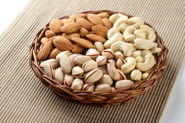 Indian dry fruits Kju, Badam and Pista in basket isolated