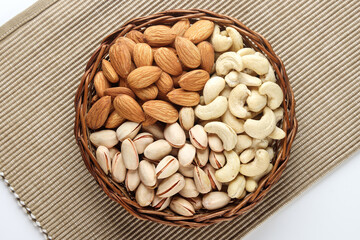 Indian dry fruits Kju, Badam and Pista in basket isolated 