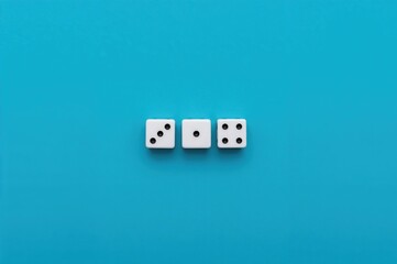 Row of dice placed on a blue surface