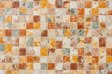 Close-up view of patterned tiles arranged in a random rectangular checkerboard design. Continuous background texture.
