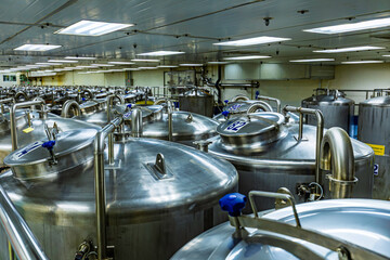 Stainless vertical steel tanks and pipes with pressure meter in equipment tank chemical cellar at the with stainless steel