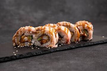 This delicious Sushi Roll is topped with savory Eel Sauce and sprinkled with Sesame Seeds