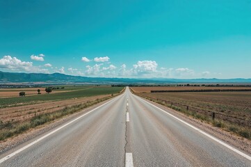 Farming zones in open grasslands under a clear blue sky on a bright sunny day with a rural path