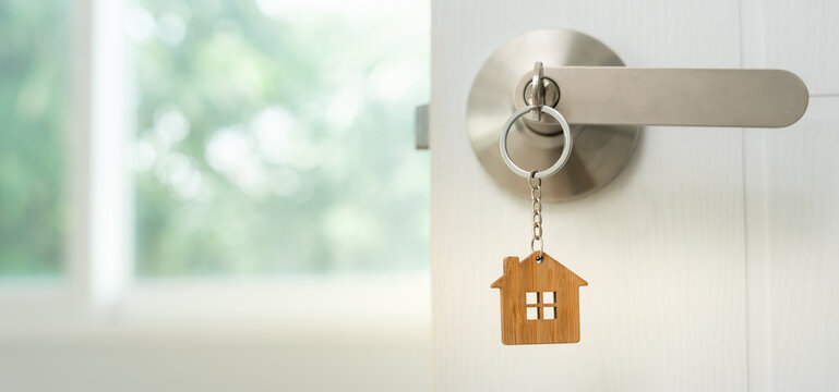 Moving house, relocation. Open the door of the new house, inside the room was a cardboard box containing personal belongings and furniture. move in the apartment or condominium