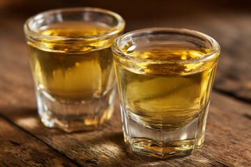 A close-up of Grogue (sugar cane rum), clear and potent, served in small traditional glasses, symbolizing local spirits.