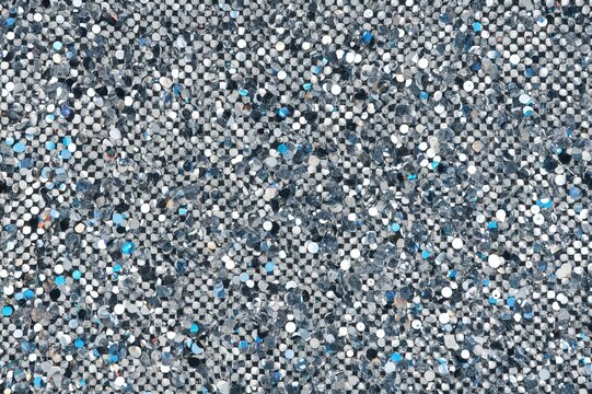 Fototapeta Silver square sequins sparkling with rainbow reflections including blue, gray, green, black, red, yellow and others. Textures and Backgrounds.