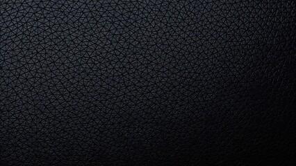 Obraz premium Close-up of black leather with fine grain texture, emphasizing its smooth and luxurious quality.