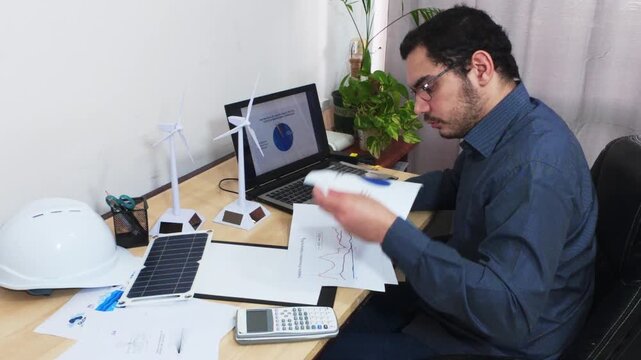 Accountant Reviewing Multiple Financial Reports with Data Charts.