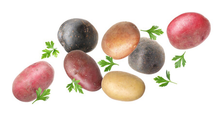 Different types of fresh potatoes with parsley flying on white background