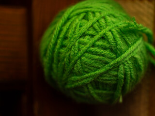 green yarn ball used for knitting sweater