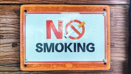 no smoking sign on a wooden wall