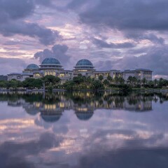 Fototapeta premium Tranquil sunrise over government buildings reflected in a calm lake