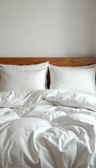Obraz premium Neatly laid out snow-white bed linen with two pillows on white duvet. Close-up front view of comfortable bed, inviting relaxation. Soft, smooth textile perfect for hotel, apartment, bedroom mockups.