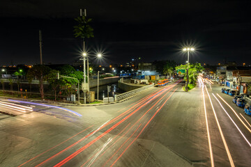 Nighttime City Traffic with Light Trails and Urban Skyline