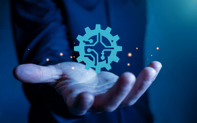 Hand holding glowing gear circuit icon for technology engineering solution.