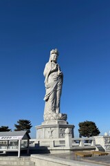 Obraz premium Large outdoor Buddhist statue under clear blue sky
