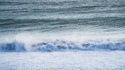 Powerful ocean waves crashing with white foam and sea spray creating dramatic seascape and water...