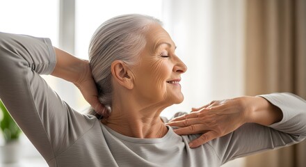Content senior woman with closed eyes stretching her neck and shoulders at home, practicing self-care and relaxation.