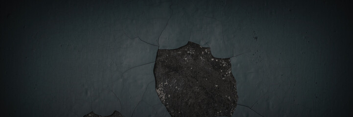 Dark wide panoramic background. Peeling paint on a concrete wall. Dark grunge texture of old...