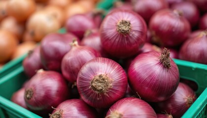 Close-up of vibrant red onions piled high in green plastic crate at noisy market stall. Fresh produce, full of flavor, ideal for cooking. These healthy ingredients are essential for vegetarian meals.