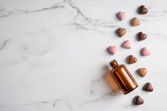 Apothecary bottle and heart-shaped chocolates arranged on a marble surface for a luxurious valentine's day display