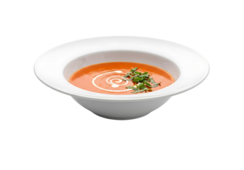 Aromatic, vibrant orange soup is presented in a pristine white bowl, adorned with a swirl of cream and fresh herbs.