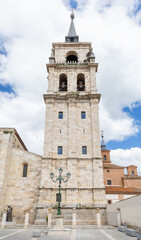 Fototapeta premium Main facade of the cathedral, with visitors waiting to enter, in the historic center of the city of Alcala de Henares, Spain