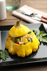 Tasty stuffed pattypan squash on wooden table, closeup