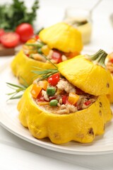 Tasty stuffed pattypan squashes on white table, closeup