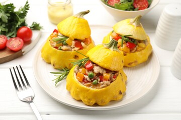 Tasty stuffed pattypan squashes on white wooden table, closeup