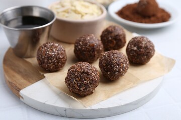Making homemade candies. Chocolate balls and ingredients on white table, closeup