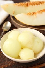 Cut ripe melon on wooden table, closeup