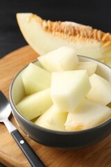 Cut ripe melon in bowl on table, closeup