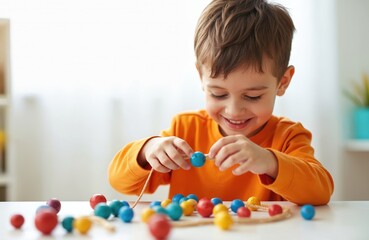 Young boy enjoys threading colorful wooden beads. Focused concentration develops fine motor skills, creativity, hand-eye coordination. Joyful childhood activity promoting early learning, playful