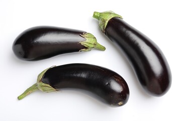 Many fresh eggplants on white background, flat lay