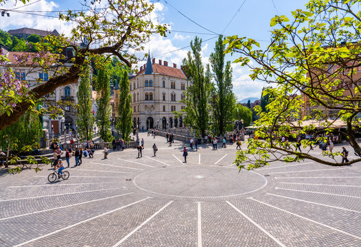 Ljubljana, Slovenia 29 april 2025 - tourists walking on the Presernov trg (square) and the triple bridge
