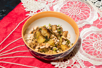 healthy boiled potato & peanut dish in a bowl with beautiful red background.