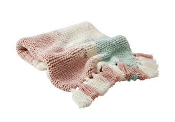 A soft, knitted throw blanket features a multicolored ombre design, transitioning from rose to mint green, with cream accents and delicate tassels.