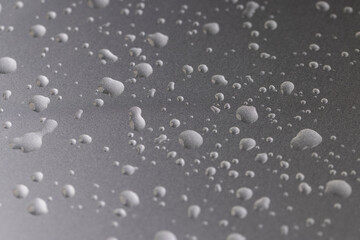 silver colored metal surface covered with water, wet silver metal painted to protect aluminum alloy and metals, close up