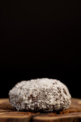 whole half sweet marshmallows in chocolate sprinkled with coconut chips, sweet dessert marshmallows in milk chocolate with coconut