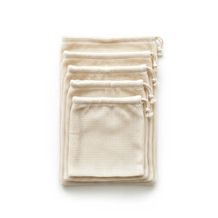 Stack of reusable organic cotton produce bags on a white background