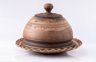 Brown Ceramic Plate with lid. Clay dish on white background. Handmade bowl craft