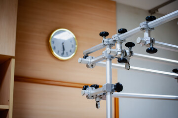 Close-up of medical equipment, a lifting beam for treating broken bones, supporting arms and legs in splints, accident, and some of the patient's beds in the recovery room.