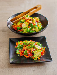 brussels sprouts hash with tomato, bacon, carrot, and bell peppers