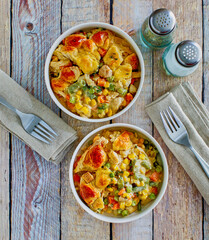 creamy chicken pot pie with onion, peas, and carrots topped with fresh thyme, 2 napkins