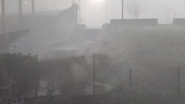 Big storm with strong wind at urban park surrounded by aparment buildings in barrio sur neighborhood, montevideo city, uruguay