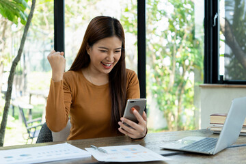 Young woman engages in note-taking at workspace.