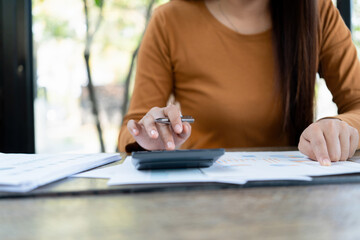 Young woman engages in note-taking at workspace.